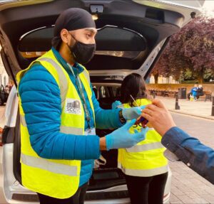 volunteers give out hot drinks