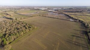 Ariel view of a field with buildings in the distance|||Winvic Construction Ltd