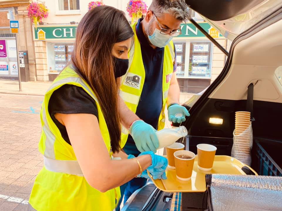 volunteers pour hot drinks||