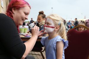 Girl having face painted atNorthampton Town Football Club at|Emergency Services Bikes