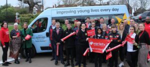 Children from Northgate pose with their new Variety coach.