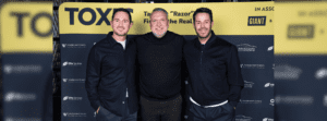 Famous faces from football Frank Lampard (right) and Jamie Redknapp (left) are standing either side of football legend Neil Ruddock (center)|Leah Ruddock pictured with husband Neil Ruddock during at the book launch event.|GIANT Team members pictured with Neil Ruddock.